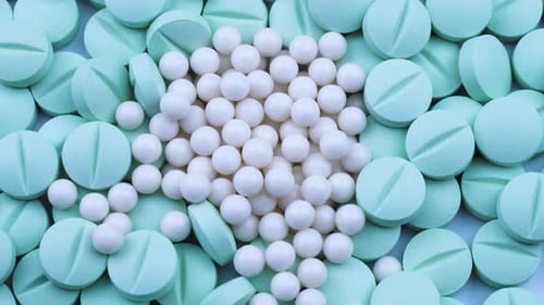 White Granules Are Scattered on Round Bright Green Antibiotics. Rotation