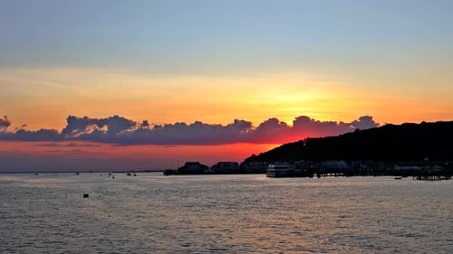 Beautiful Sunset Over Colorful Ocean with Reflection in Water, Majestic Clouds on Sky