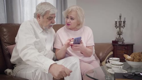 Senior Couple Looking at a Mobile Phone Together