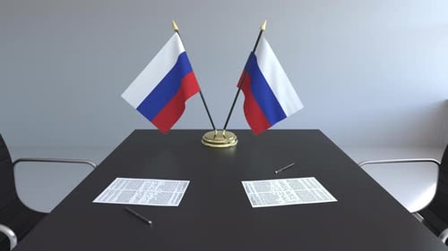 Fluttering Russian Flags on a Corporate Meeting Table