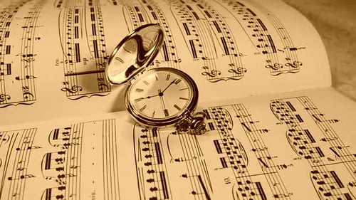 Vintage Pocket Watch Lying on Sheet Music