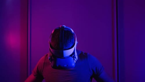 Man Using Virtual Reality Headset in Dark Room