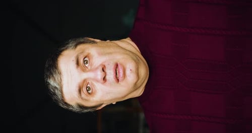 Man Stares into Camera with Surprised Expression