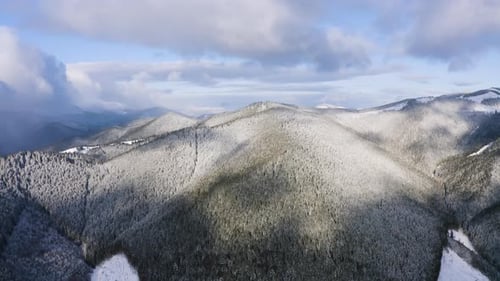 Winter Scenery in Mountains. Aerial Drone View of Snowy Forest on the Hills