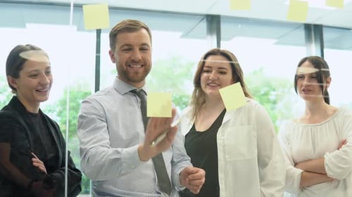 Group of Young Entrepreneurs Discussing Business in Company Meeting Room