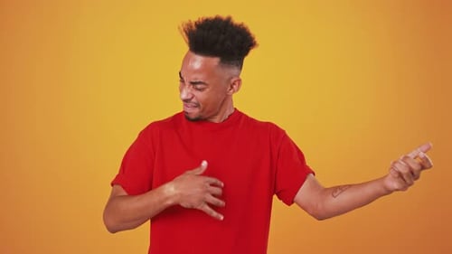 Black Guy Stunning Solo on Invisible Guitar Orange Studio Background Slow Motion