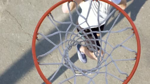 Male Athlete Shooting a Ball Through the Basket, Professional Basketball Player