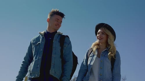 Cheerful Couple Walking in Countryside on Sunny Day