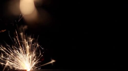 Gold Sparklers Against Black Background