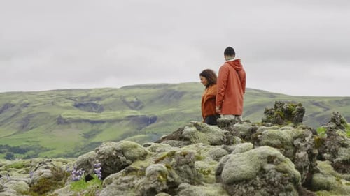 Couple Exploring Mossy Green Hills Landscape Together