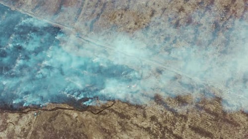 Aerial View. Spring Dry Grass Burns During Drought Hot Weather. Bush Fire And Smoke In Meadow Field