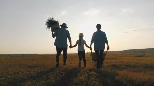 Family Walking on Farm at Sunset