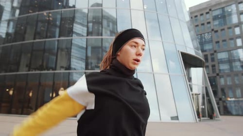 Woman Stretching Before Workout in Modern City