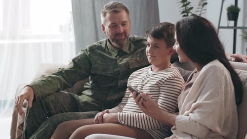 Family Together on Couch Taking Cell Phone Picture