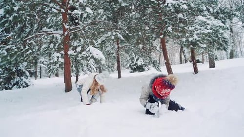 Kinder spielen draußen im Schnee. Glückliche Kinder, die Spaß haben, im Winter spielen, draußen spazieren gehen