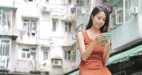 Woman Using Smartphone in an Urban Setting