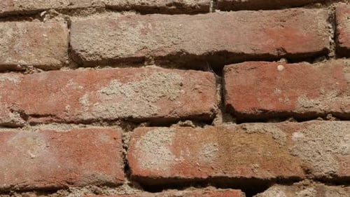 Ancient wall with red clays and cement for backgrounds 4K 2160p 30fps UltraHD titlting video - Slow