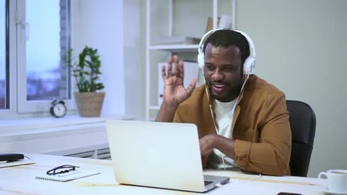 Adult Man Video Conferencing at Office Desk