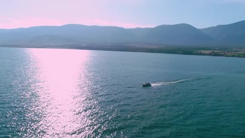 Aerial View Boat Flying Droneg. Small Ship Floats on a Sea Surface Leaving a Path of Sea Foam Water.