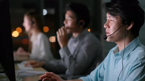 Asian operator or call center team with worker sit in front computer monitor also talk to customer