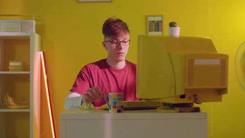 Young Adult Using Old Computer