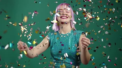 Hipster Woman with Sparkling Bengal Fire Dancing Under Confetti Rain on Green Background