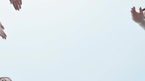 Friends Make a Circle with Their Palms Against the Blue Sky