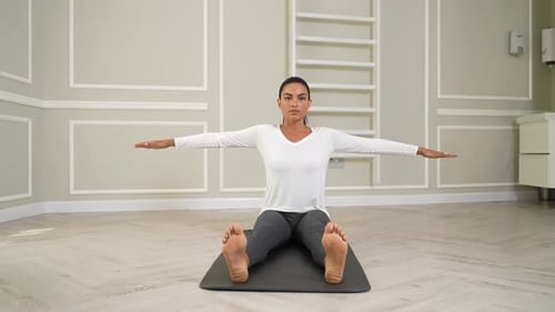 Woman Doing Seated Spinal Twist Exercise Indoors