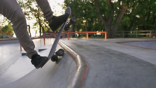 Skateboarder Doing a Tricks in a Concrete Skate Park Close Up Slow Motion