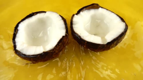 Coconuts Floating in Yellow Liquid Close Up