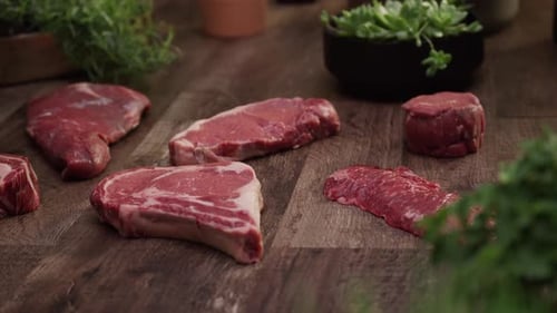 Selection of Raw Beef Cuts on Wood Surface