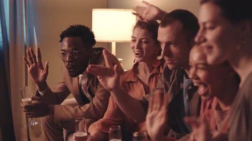 Friends Cheering Together in a Home Living Room