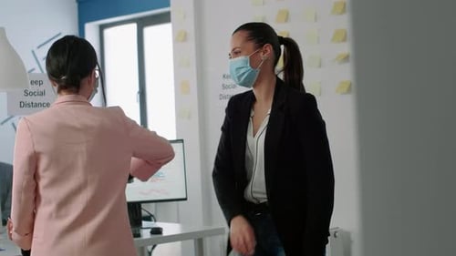 Businesswomen Greet in the Modern Office Space