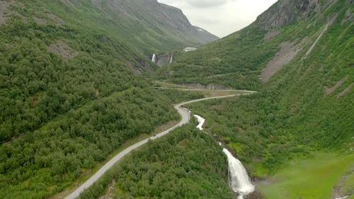 Aerial View Of Road In Mountains And Forest Landscape In Stryn, Norway - drone shot