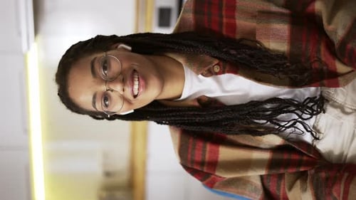 Smiling Young Woman with Braids Indoors