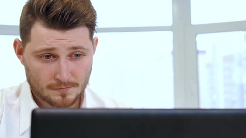 Male Manager Uses Laptop at the Office