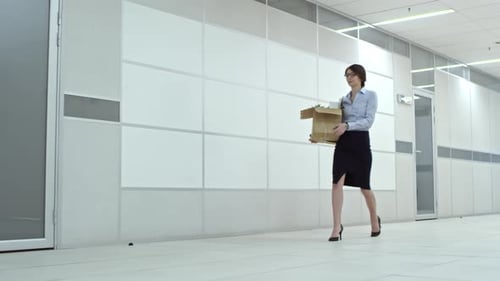 Female Office Worker Walking with Belongings