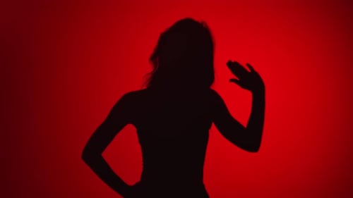 Woman's Silhouette Dancing on Red Background