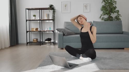 Young Woman Stretching Neck at Home