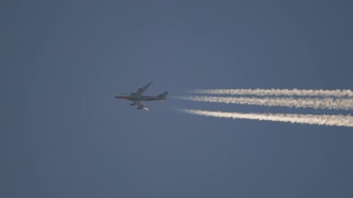 Airplane Soaring Through Sky Leaving Contrails