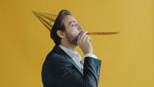 Man in Suit Blows Party Horn with Joy