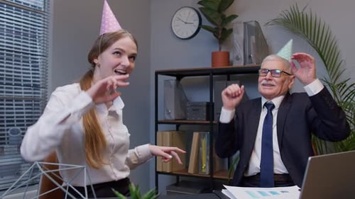 Smiling Secretary with Handsome Senior Businessman Company Director Dancing Victory Dance in Office