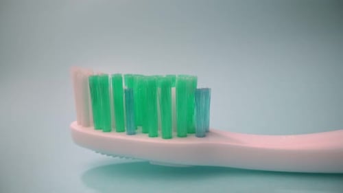 Toothpaste Being Squeezed Onto Toothbrush in Close Up
