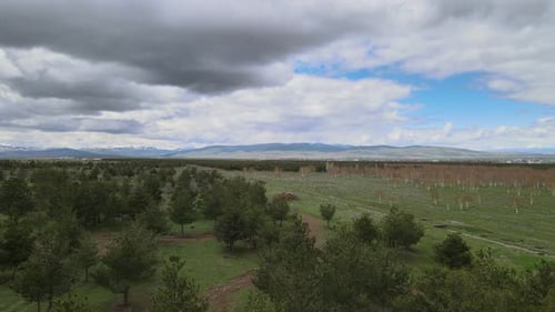 Scenic Landscape with Green Fields and Clouds