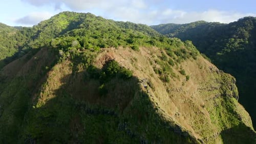 Beautiful Aerial Footage of the Grassy Top of the Mountain Under the Bright Sun.