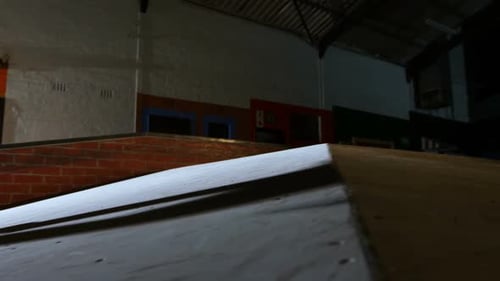 Young Man Skateboarding on Ramp, Doing Trick