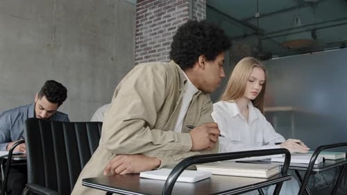 Group Diverse Students Sit in Classroom Write Exam Test Concentrated Pupils Writing Control Work