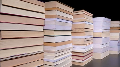 Stacks of Books Piling Up on Black Background