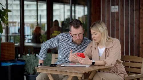 Couple Using Modern Gadgets in City