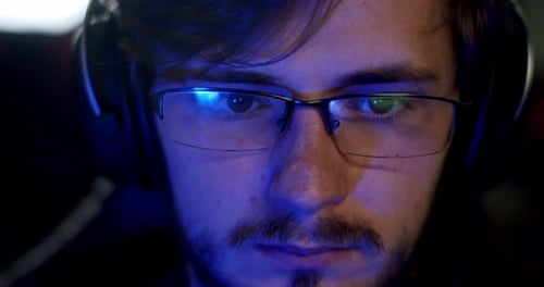 Concentrated Young Adult Wearing Headphones Indoors